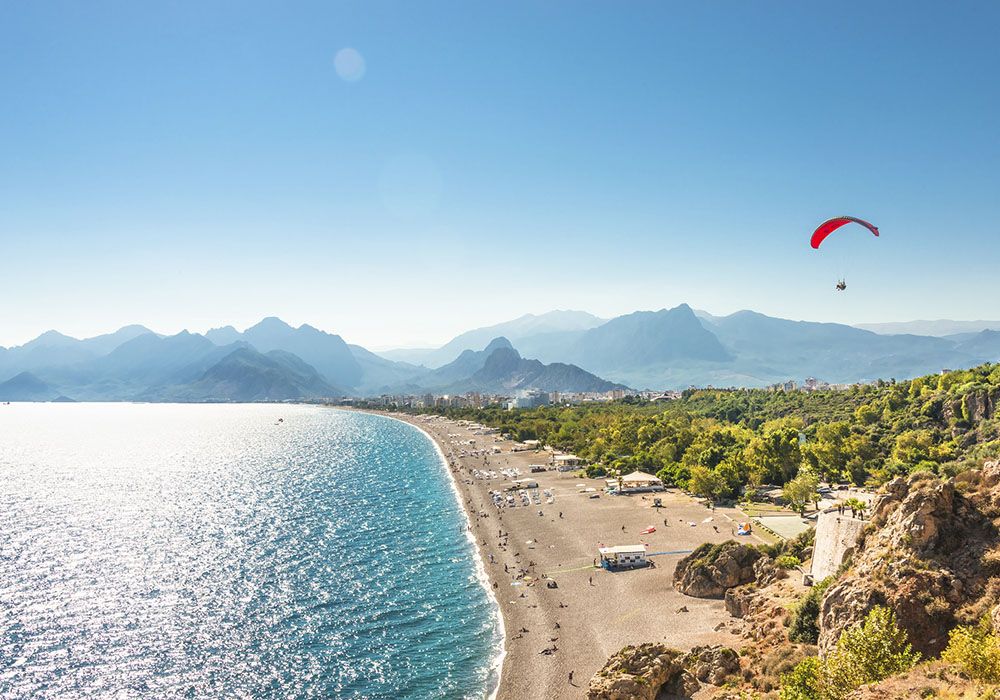 Panoramic bird view of Antalya and Mediterranean seacoast and beach with a paraglider, Antalya, Turkey